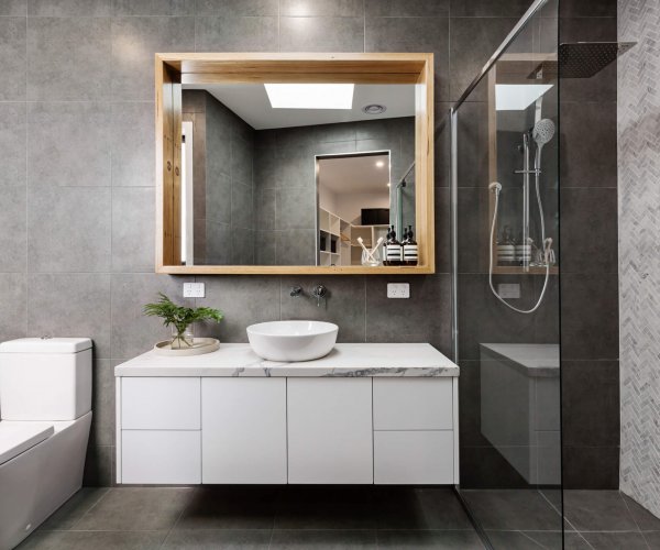 Modern grey designer bathroom with herringbone shower tiling