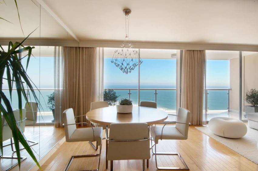 Dining-room-with-a-mirrored-wall-and-an-ocean-view